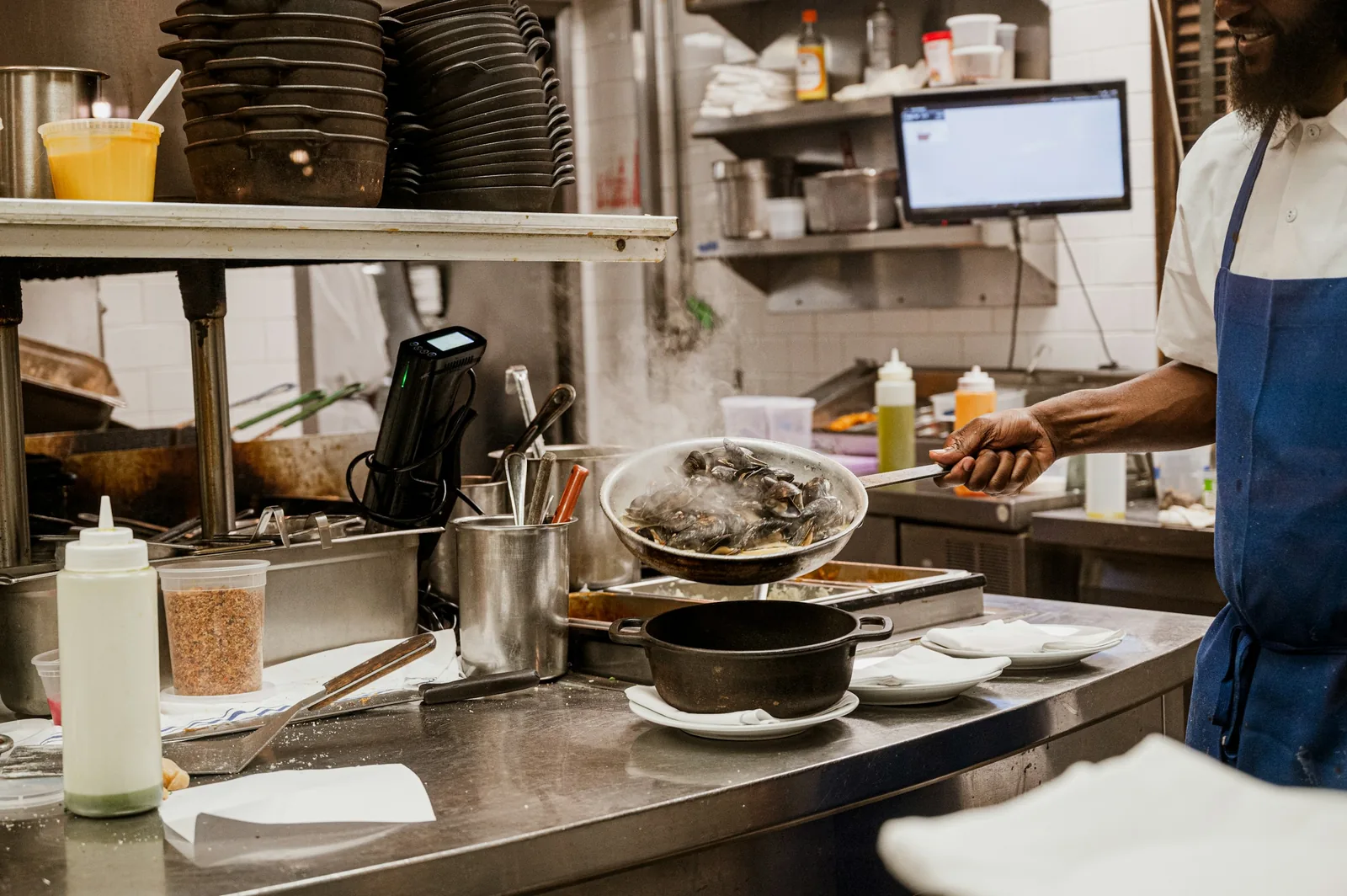 Chef preparing food at a commercial kitchen station